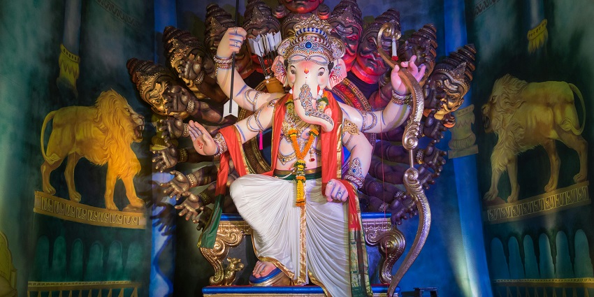 A picture of a Ganesha Idol at a big pandal with beautiful lighting