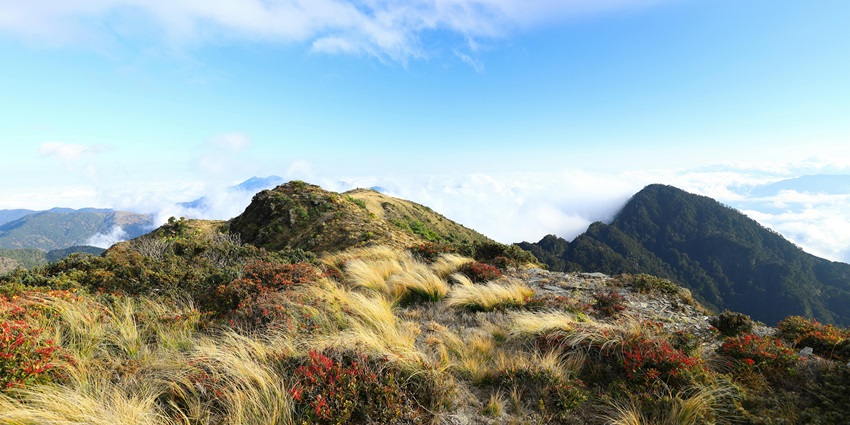 Hikers carrying proper gear prepare for a challenging mountain trek