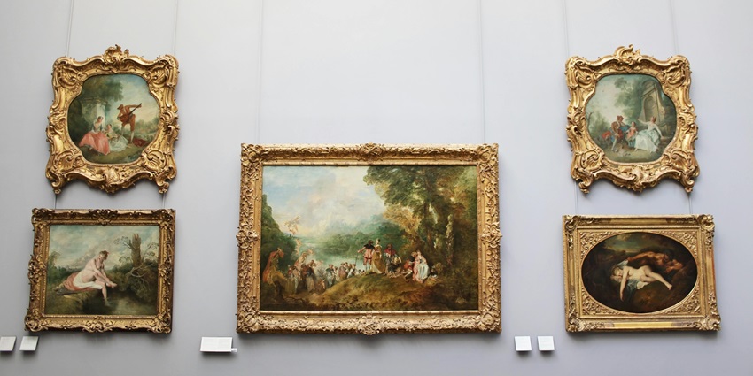 A picture of a wall with historical paintings hung all over