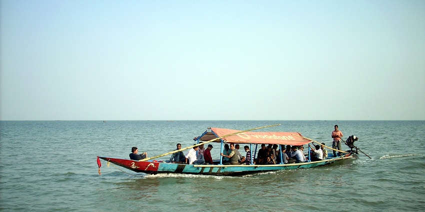 Tourists enjoying a boat ride across Chilika Lake with nothing else in sight but water