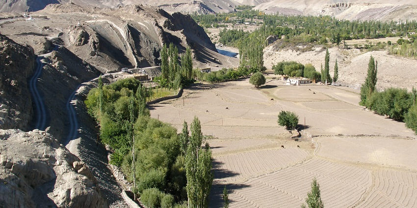  Image of Alchi, Indus Valley surrounded by lush greenery and mountains under blue sky