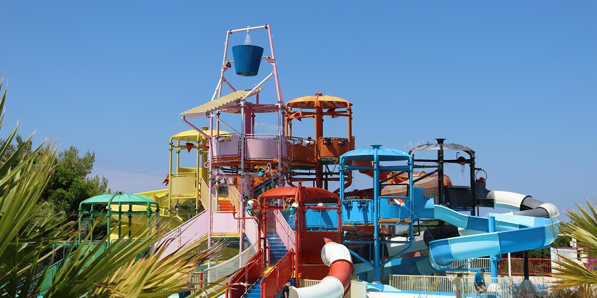 A picture of a water park with multiple water slides visible