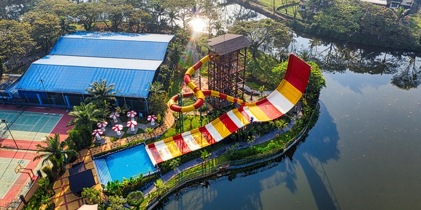 Happy children enjoying thrilling water slides, splashing into a bright blue pool.