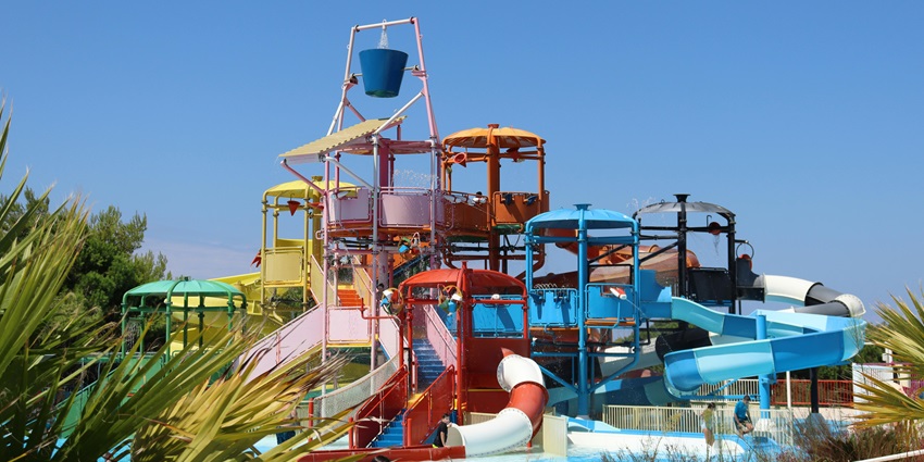 Cheerful child enjoying colourful playtime, just like at Fun Planet Water Park.