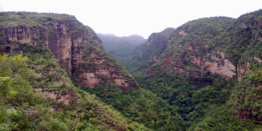 Scenic view of Pachmarhi with lush greenery and a waterfall, one of the best places to visit in Madhya Pradesh for couples