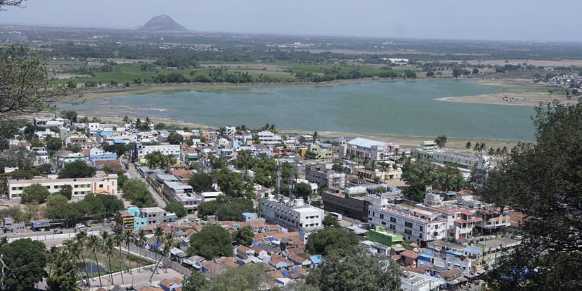 An aerial view of a city settlement along the shore of a water body