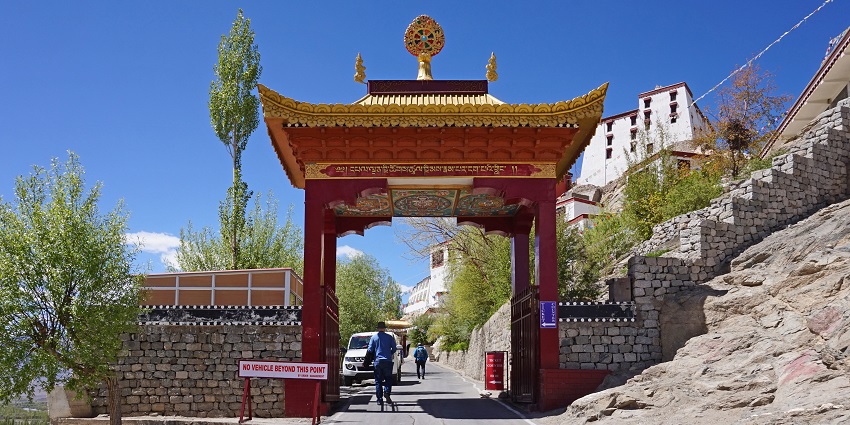 Image of a monastery gate with beautiful architecture surrounded by mountains