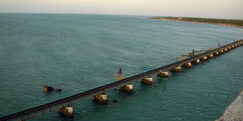 Aerial view of a bridge in Pamban Island with a clear blue sky in the background.