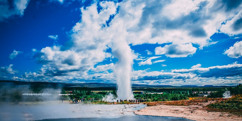 Scenic view of the panamik hot springs, surrounded by greenery and dynamic clouds in the sky
