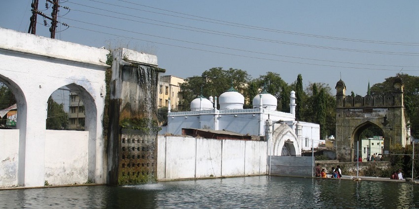 The picturesque setting of Panchakki features a historic watermill surrounded by gardens.