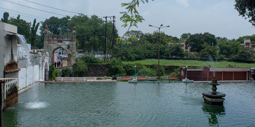 Ancient Panchakki water mill and gardens in Aurangabad with stone walls and arches.