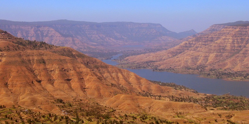 An aerial view of Panchgani's Table Land surrounded by hills, offering stunning views