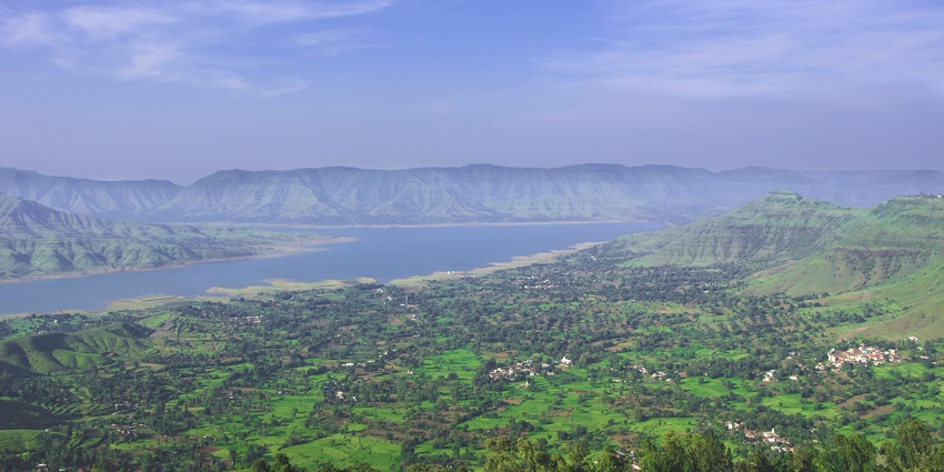 A bird’s eye view of the colourful village, azure waters and lsh greenery of Panchgani.