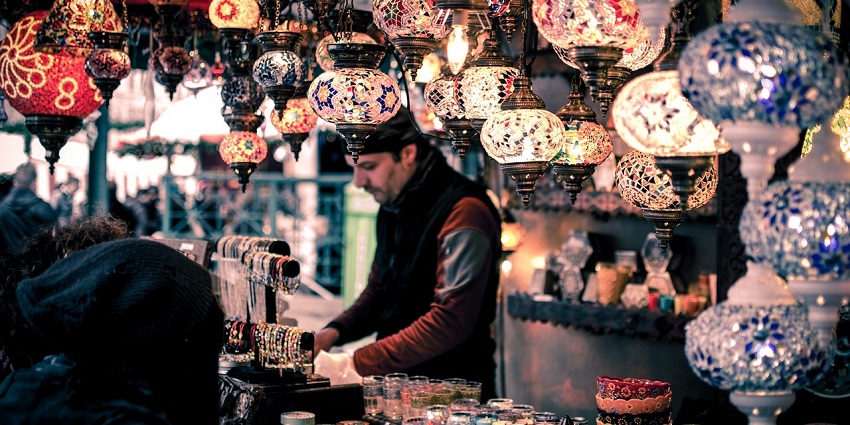 A bustling local market with stalls selling Bracelets and lanterns for Decor