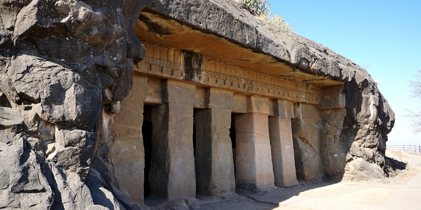 Pillars at the entrance of a rock-cut cave at Trirasmi Caves in Nashik District
