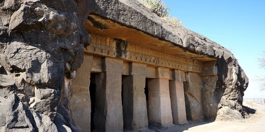 Pillars at the entrance of a rock-cut cave at Trirasmi Caves in Nashik District.