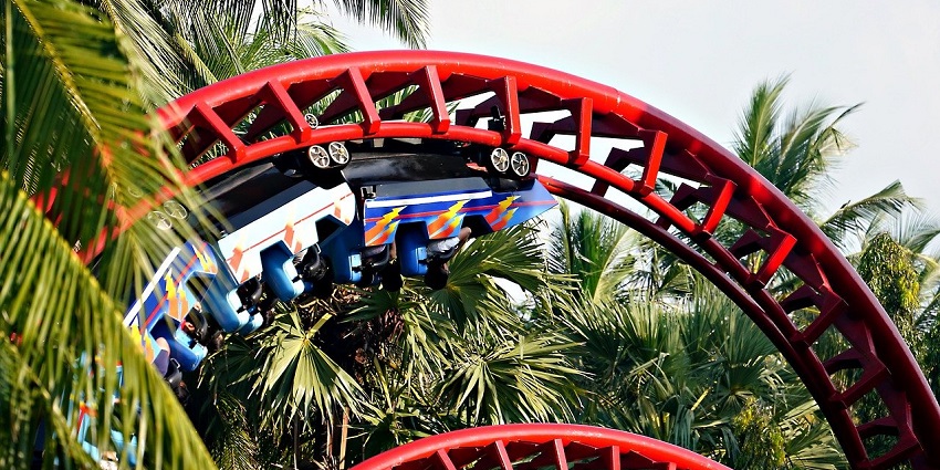 Colorful roller coaster at Pandavleni Water Park with riders enjoying the thrill.
