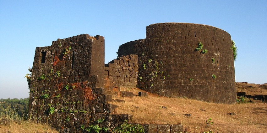 The rampart of Panhala Fort, showcasing ancient stone walls set against the open sky.