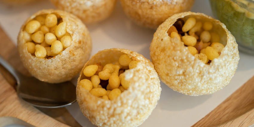 The street food in Pondicherry offers puris filled with spicy water, a popular street snack.