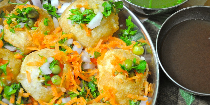 An image of a Pani Puri - a popular street snack featuring crispy puris filled with tangy water.