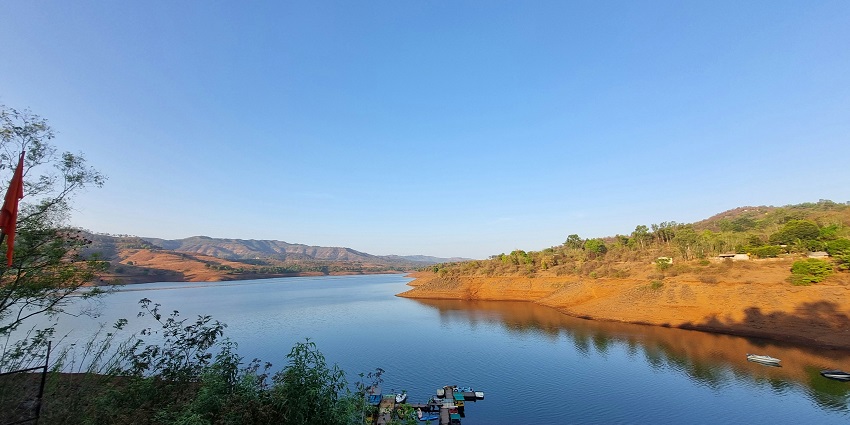 Several vibrant coloured boats are present in the backwaters of the Panshet dam.
