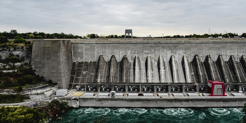 The Panshet Dam, a large earthen dam. The dam is surrounded by lush green hills and wate