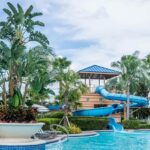 A vibrant swimming pool in Panshet water park filled with people enjoying leisure time under the sun.