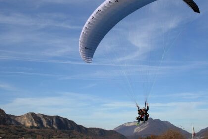 A child enjoys a thrilling ride while paragliding in Ladakh's stunning landscapes.