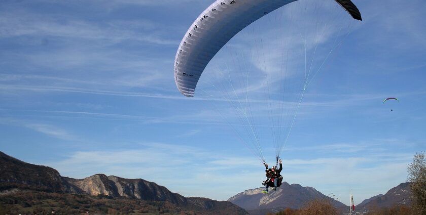 A child enjoys a thrilling ride while paragliding in Ladakh's stunning landscapes.