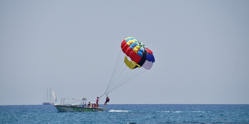 A picture of parasailors soaring high above the Arabian Sea - Alibaug Beach water sports.