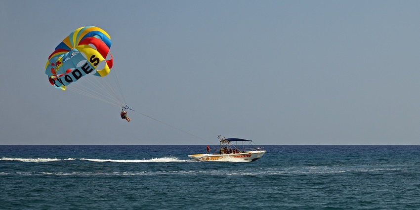 Experience parasailing where you're lifted into the air by a parachute while being towed.
