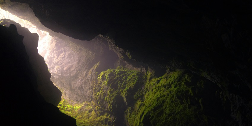 A representative picture showing ancient rock-cut sculptures and serene landscapes.