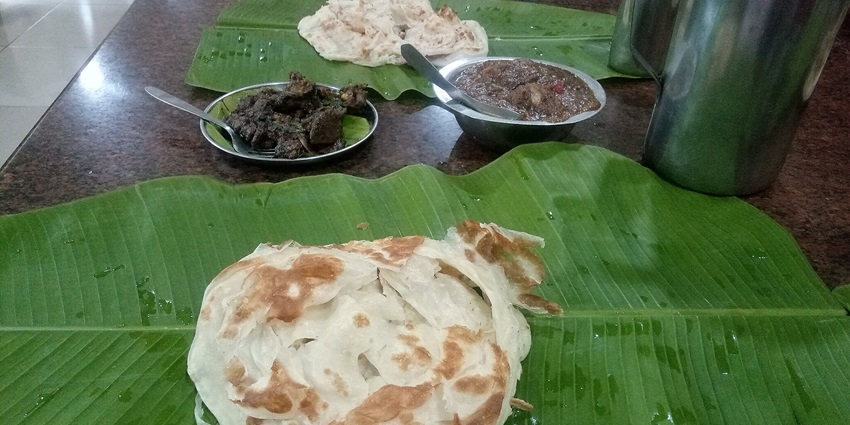 Soft parottas accompanied by spicy salna at Perumal Malai.