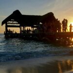 Image of a beachside and a shack, people partying duirng beautidul sunset - party places in South Goa