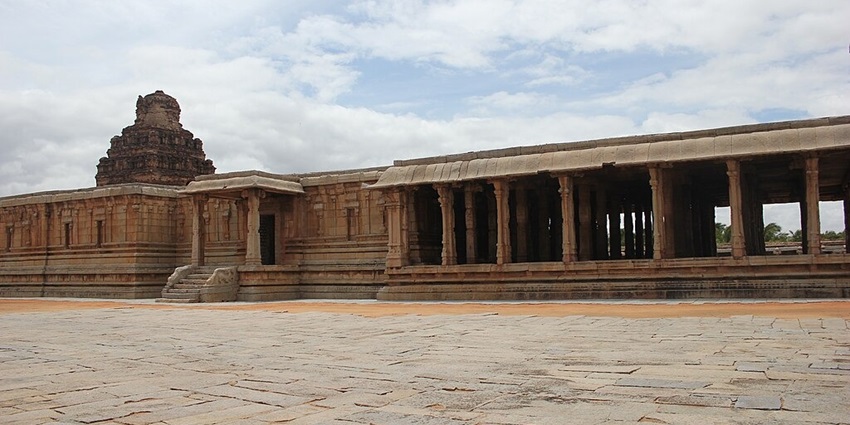 An exterior view of an ancient Hindu structure with stone carvings.