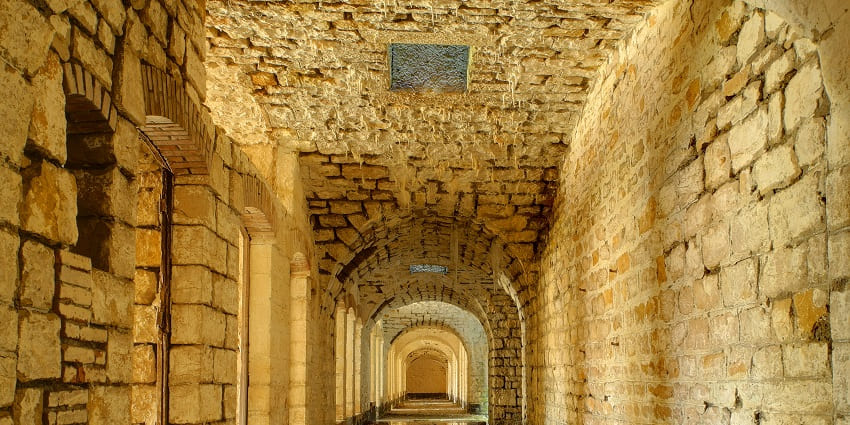 A walkway in Pavagada Fort, one of the places to visit near Tumkur, against clear blue sky.