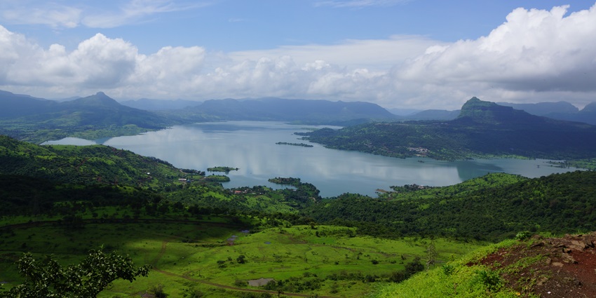 The hilltop from the Lohagad Fort is surrounded by other fort hills with Pavana Lake in view.
