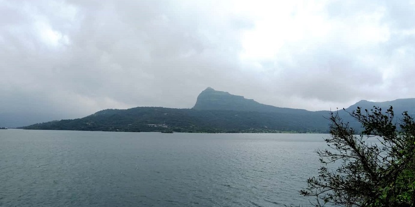 Serene lakeside view of Pawna Lake in Lonavala, perfect for nighttime camping and bonfires.