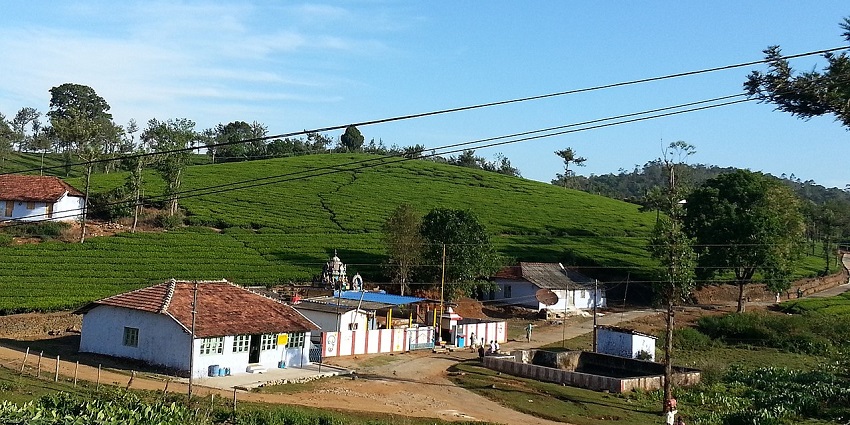 A picture of Peermedu with misty hills and scenic landscapes, featuring some quaint houses