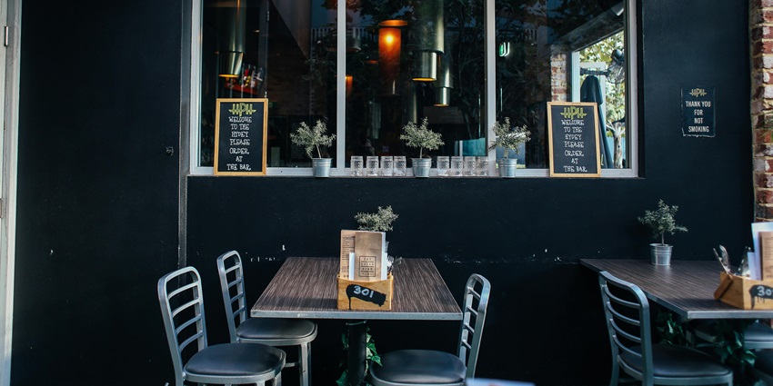 Cozy bar interior with wooden tables, ambient lighting, and rustic decor–nightlife in pune for singles