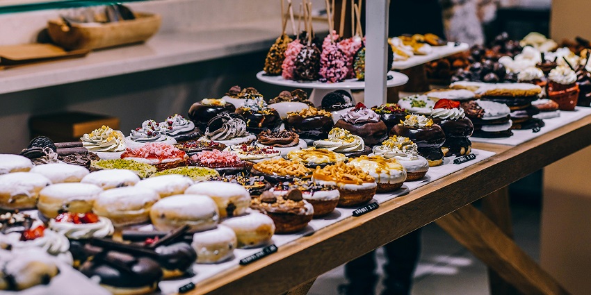 A picture of sweet delicacies displayed in a shop, tempting passersby.