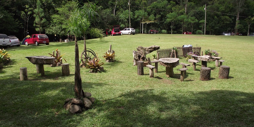 A serene picnic garden with lush greenery and well-maintained grassy areas.