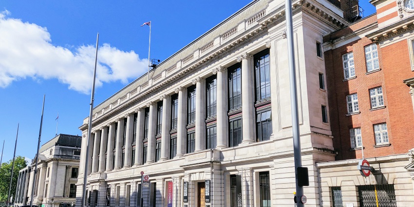 A picture of a building taken from a distance on a clear sunny day