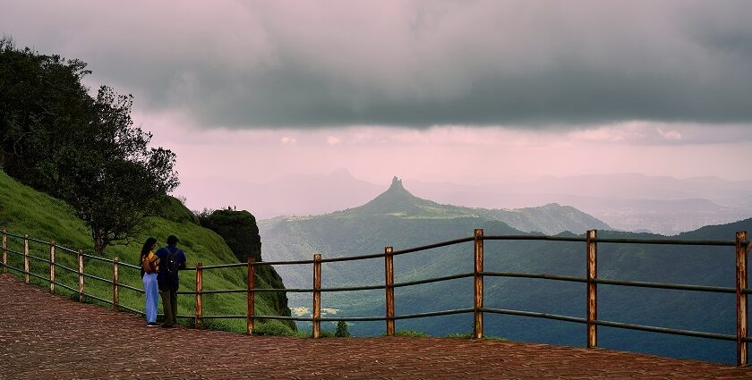 An image of a couple at Irshalgad fort peak as seen from Malang Point at Matheran.