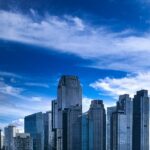 A scenic view of towering skyscrapers, buildings, and bright blue skies in Indonesia.