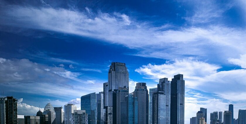 A scenic view of towering skyscrapers, buildings, and bright blue skies in Indonesia.