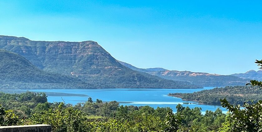 A breathtaking vista of shimmering blue waters surrounded by majestic green peaks.