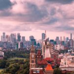 A vibrant fusion of modern skyscrapers and historic architecture gleams.