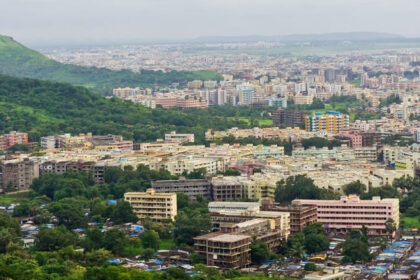 A vibrant aerial view of places to visit in Virar showcasing lush greenery amidst urban buildings.