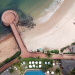 Aerial view of Aguada Fort Lower, North Goa surrounded by beach and lush greenery